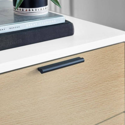 Close-up of the Alba bedside cabinet drawer in oak effect finish with a black handle, highlighting the modern and sleek design.