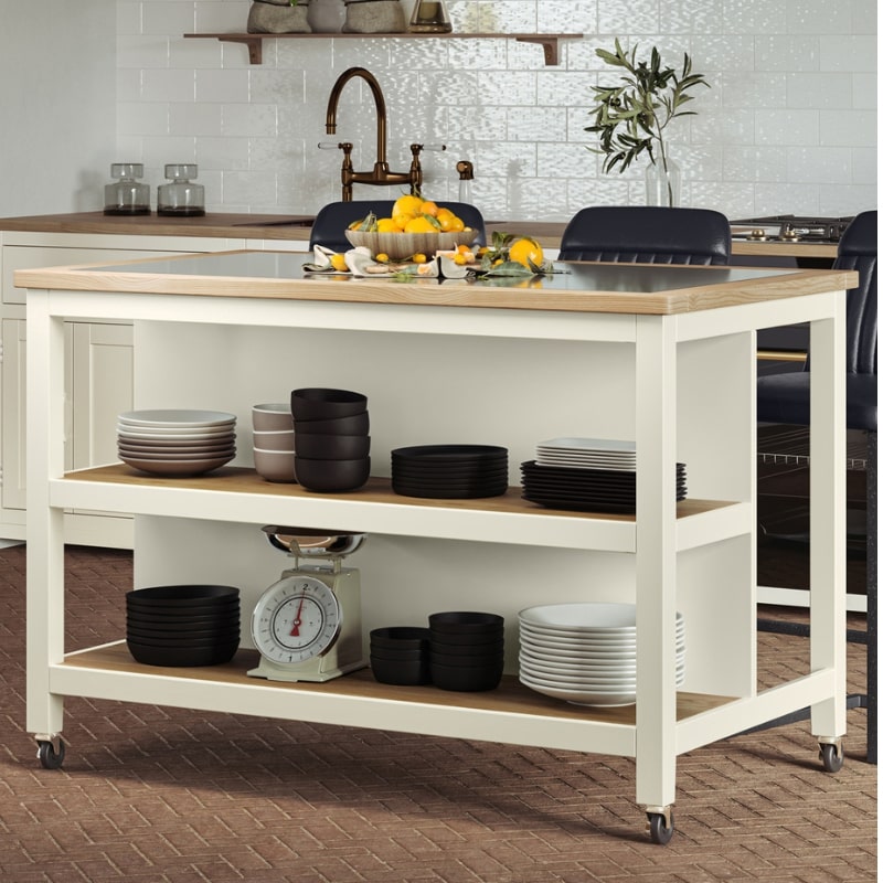 Discover the versatile Open Kitchen Island w/ Breakfast Bar in cream colour. Features black granite top, oak shelves, and braked wheels for easy mobility.