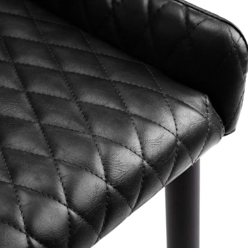 Close-up of the seat of the Luxe Faux Leather Dining Chair showcasing the diamond-quilted pattern and smooth faux leather texture.